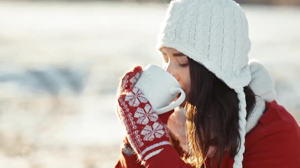 Woman Making Love Heart From Fingers at Morning Winter Sunrise