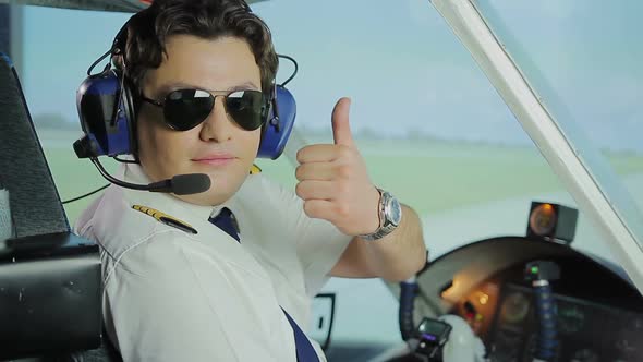 Professional Aviator Making Thumbs Up Sign for Camera, Reliable Airline Services