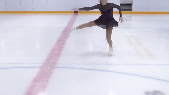 Teenage Ice Skater Skating Backwards And Spinning