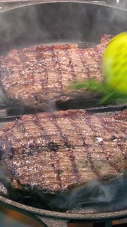 Cooking Rib Eye Steak with Herbs in a Grill Pan