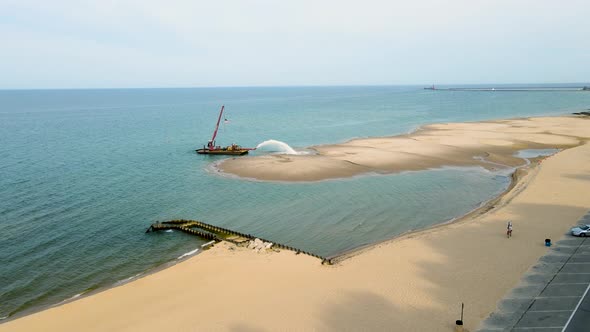 Dredging the beach at Pere Marquette. Drone Rising over the scene.