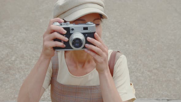 Attractive young photographer with a retro camera