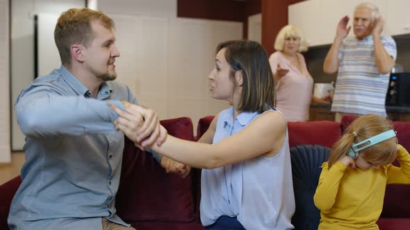 Wife and Husband Quarrelling at Home, Man and Woman Screams Each Other. Child Try To Be Distracted