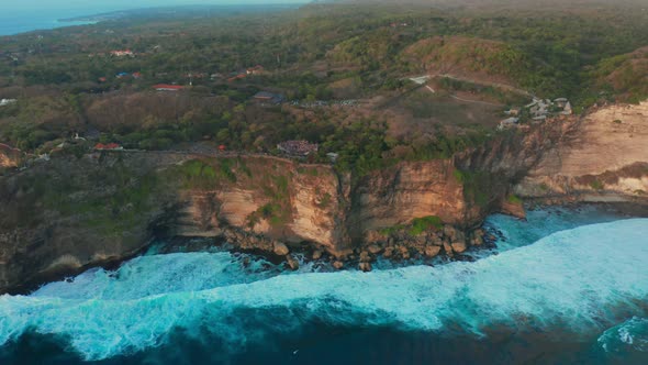View on Big Ocean Waves and Rocks at the Uluwatu Temple at the Bali Island Indonesia