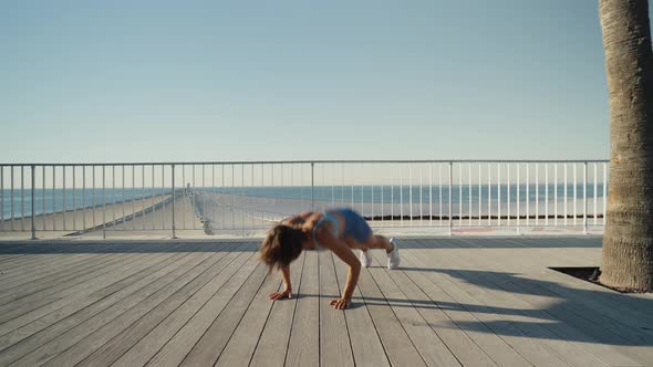 Sportswoman Workout Outdoor on Seaside  She Make Burpee Exercise