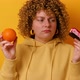 Portrait of Frustrated Hesitating 30s Woman Wearing Casual Jumper Holding Sweet Cake and Fresh - VideoHive Item for Sale
