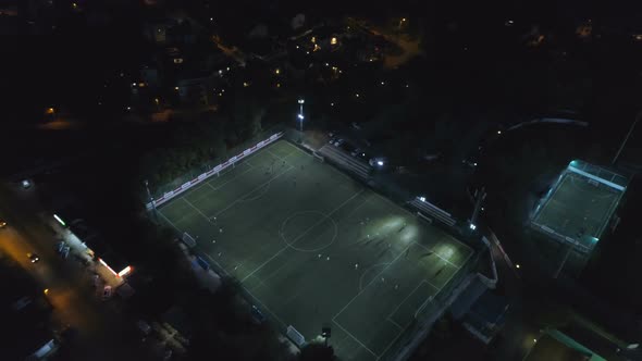Bird's Eye Aerial View Of Fooball Field During A Game Lit Up At Night At Sports