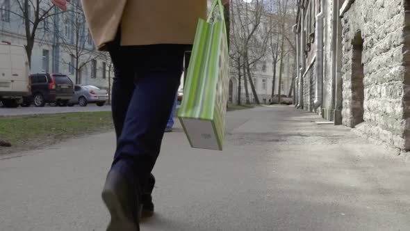 Woman Walking in the City and Carrying Shopping Bag