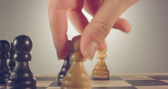 Special tracking macro shot moving between chess pieces on a chess board