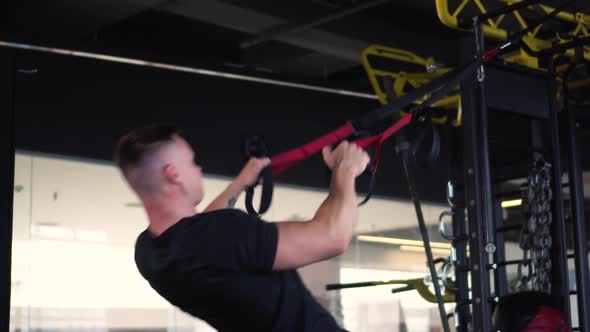 Muscular Man is Engaged in the Gym