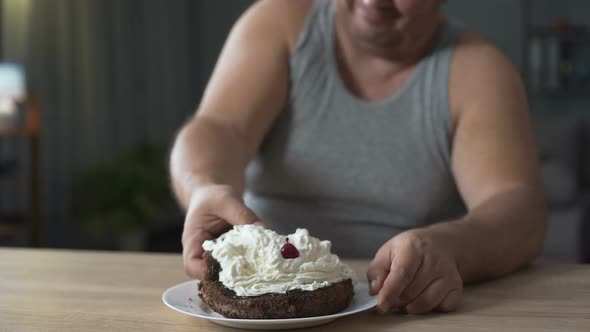 Obese Person Eating Cake with Whipped Cream Greedily and Quickly, Addiction