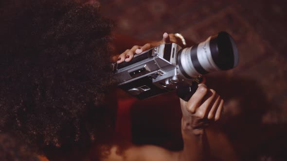 Woman With Afro Hair Filming With Vintage 8Mm Camera