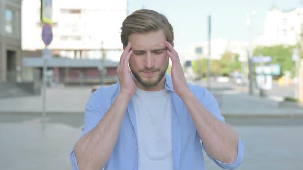 Portrait of Man Having Headache Outdoor