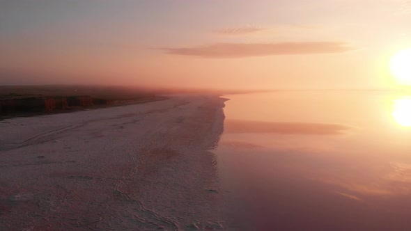 Aerial Drone View to Misty Salt Mineral Lake with Pink Water and Coastline