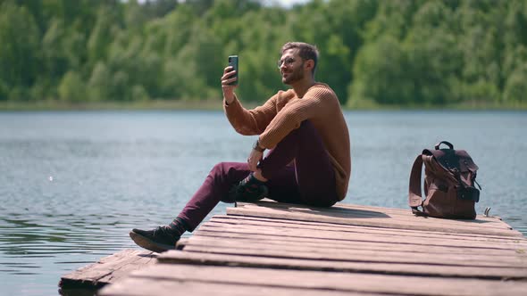 Brave Man Taking Photograph in Forest Lake with Smartphone Photographing Scenic Landscape Nature