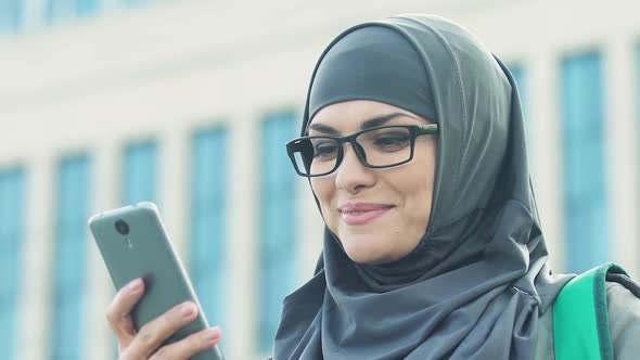 Muslim Female Tourist Using Navigator in Phone, Travel Ban for Islamic Women