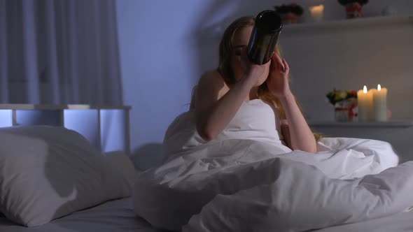 Young Woman Suffering Major Depression, Drinking Wine in Bed, Alcohol Addiction