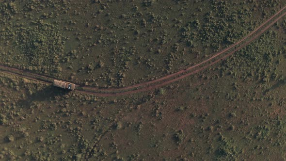 Top down aerial drone of 4 wheel drive vehicle on wildlife safari in Kenya, Africa