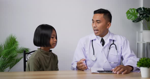 Doctor using stethoscope listen to the heart of girl in the clinic