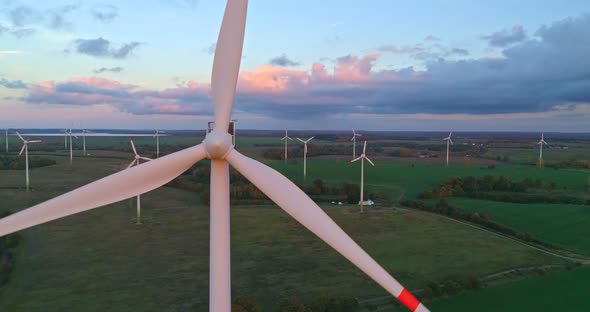 Timelapse aerial video of wind turbines at sunset