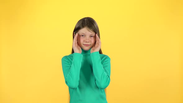 Pretty Girl with Long Hair Covers Her Face with Her Hands