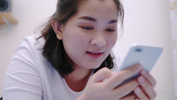 Beauty asian woman looking and touching smartphone relax enjoy and smile with online social media in