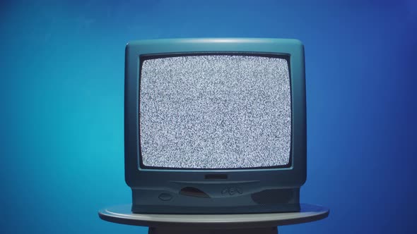 Old Vintage Television on Blue Neon Background Closeup