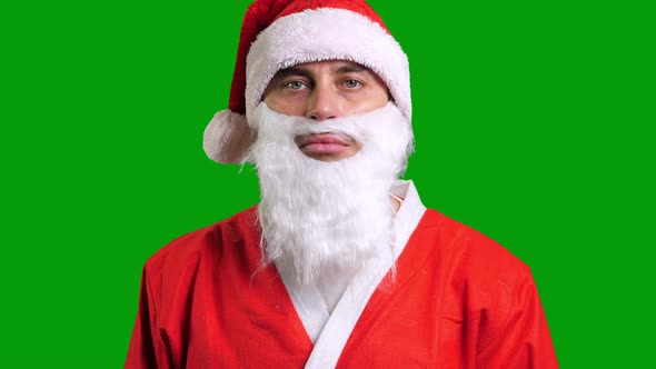 Santa Claus in Red Costume Standing and Smiling on Green Chroma Key Background