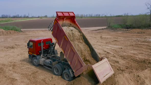 Dump Truck Unloads Sand in Construction