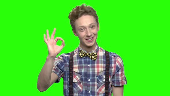 Portrait of Teen Caucasian Boy with Ok Sign