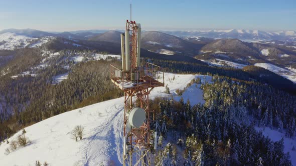 Flying Over Radio Communications Tower Mountain Snow Covered Winter Landscape