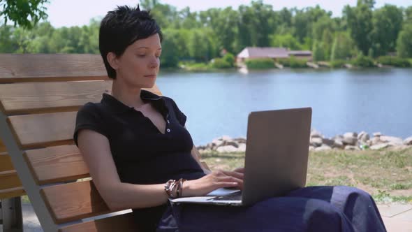 Female Working on Laptop Outdoors