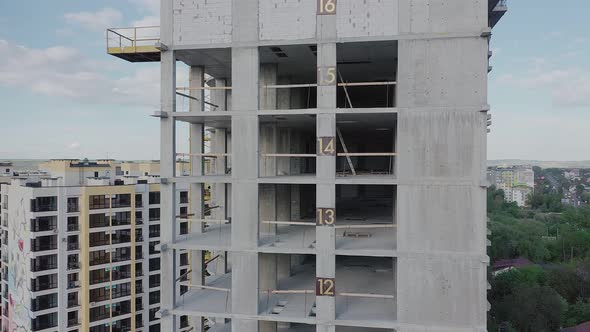 Aerial view of high residential apartment building under construction. Real estate development.