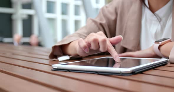 Woman use of tablet computer at outdoor coffee shop