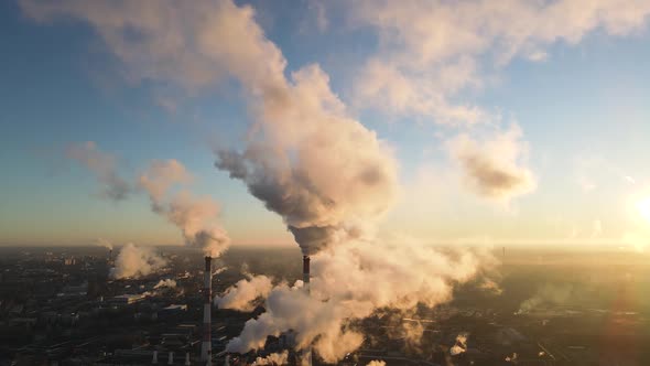 Aerial view of high smoke stack with smoke emission