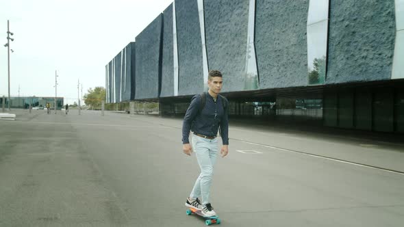 Well-Dressed Entrepreneur businessman Portrait of a Young Attractive Trendy Man skateboarding on a s