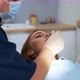 The Dentist Examines the Woman's Oral Cavity Using a Dental Mirror - VideoHive Item for Sale