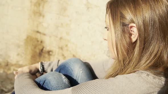 sad woman portrait: young and lonely woman sitting depressed and bored