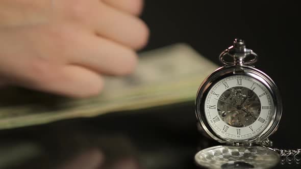 Male Hands Counting Money Behind Expensive Pocket Watch, Don't Waste Your Time