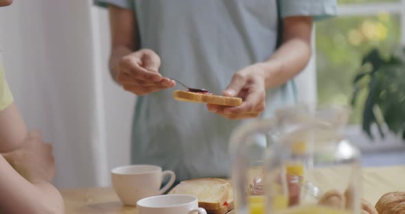 Male Gay Couple at Home in Kitchen Making Breakfast Together