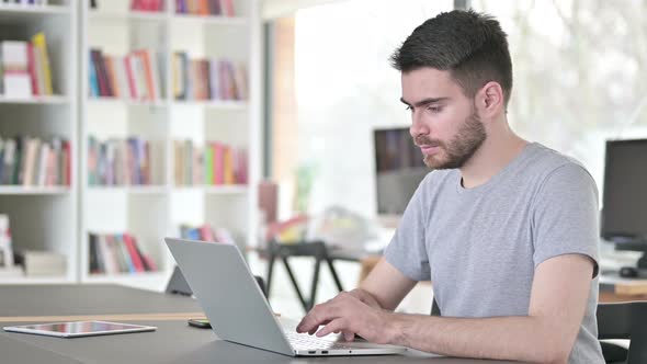 Laptop Use By Professional Young Man in Office 