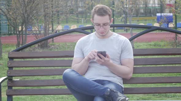 Man In The Park Speaks On The Phone