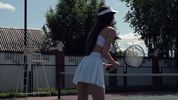 Crop Woman Playing Tennis on Court