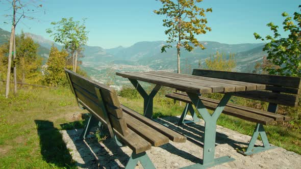 Green Lawn with Table and Benches Against Mountain Valley