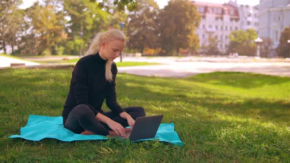 Blonde Girl Works Outdoors