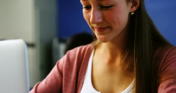 Student using laptop in classroom