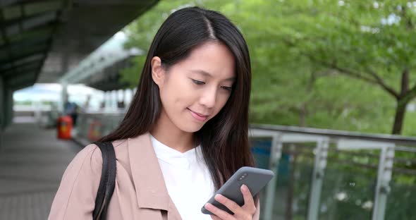 Woman use of mobile phone in city