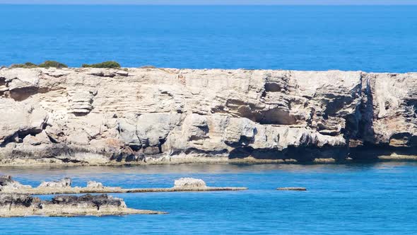 Large Stones in the Middle of Blue Sea Water Landscape Footage of Ocean Blue Water and Rocks Sunny