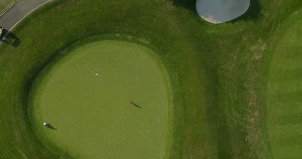 Top Down Aerial Pan of People Playing Golf on a Sunny Day