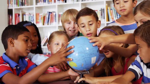 School Kids Studying Globe in Library